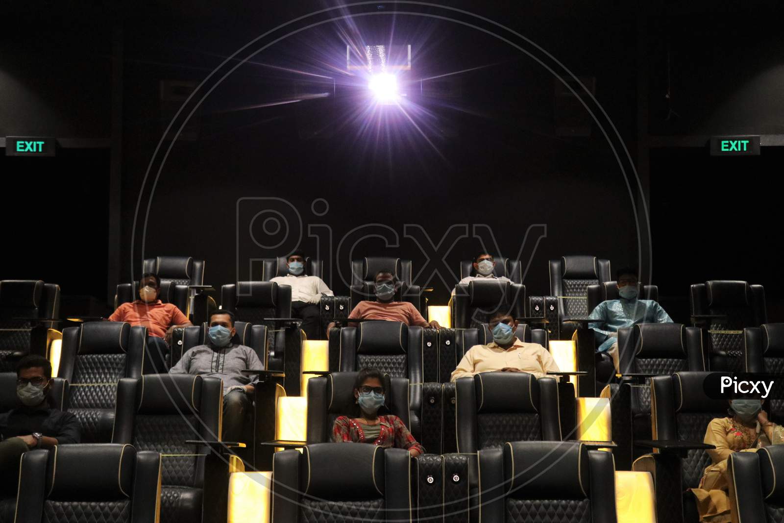 People wearing face masks as a precaution measure are seen at a movie theatre amidst the outbreak of the coronavirus disease (COVID-19), in Mumbai, India on November 15, 2020.