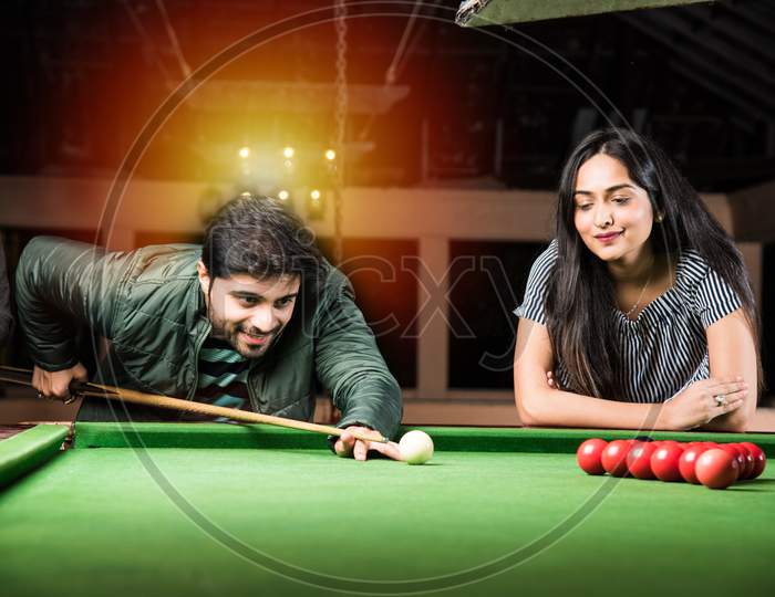 Asian Indian Friends Playing Pool, Snooker Or Billiards