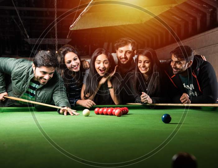 Asian Indian Friends Playing Pool, Snooker Or Billiards