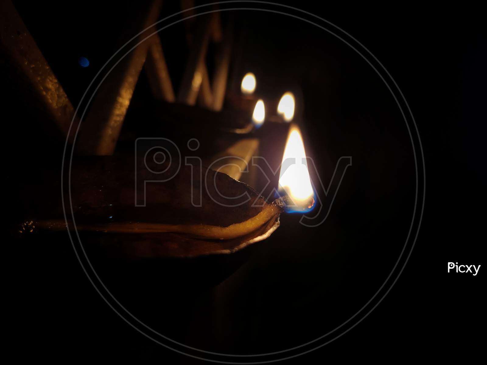 this is a picture of burning oil lamp in dark.