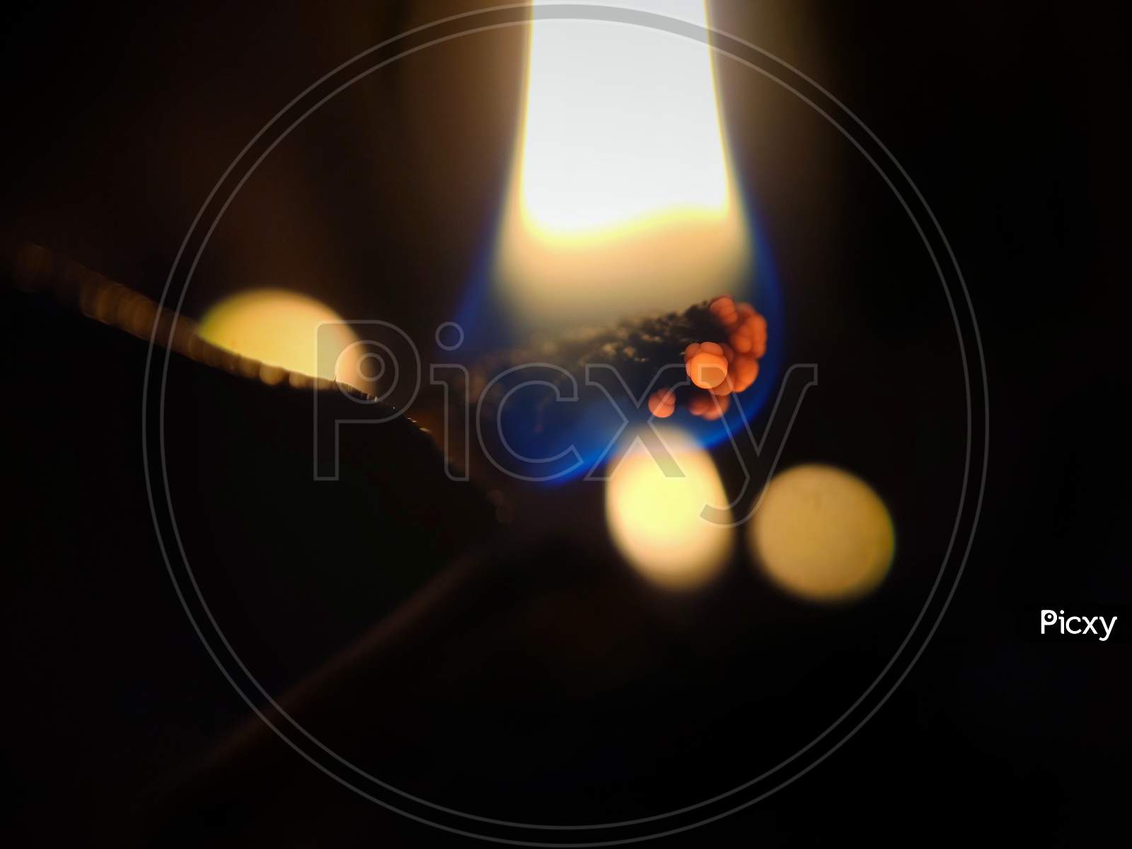 this is a picture of burning oil lamp in dark.