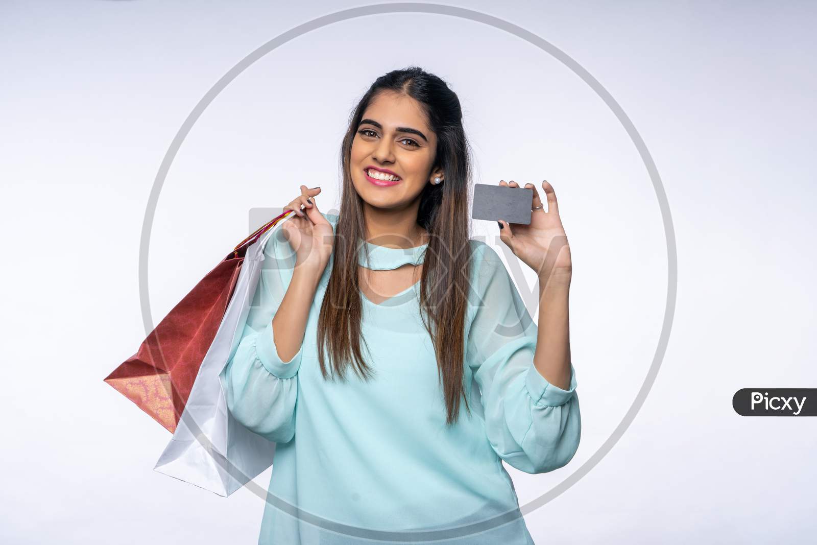 Indian young woman with a Card and Shopping bags