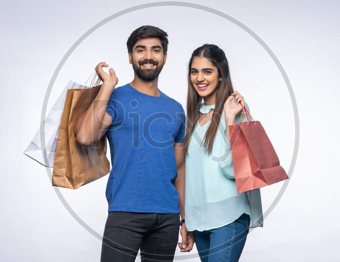 Young Indian couple carrying Shopping Bags