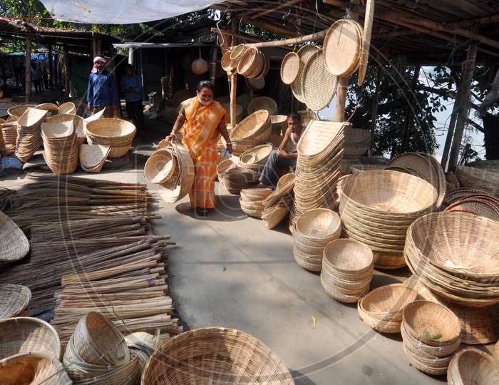 A woman buys bamboo baskets ahead of 'Chhath' festival in Guwahati on Nov 18,2020.