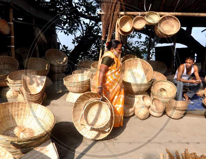 A woman buys bamboo baskets ahead of 'Chhath' festival in Guwahati on Nov 18,2020.