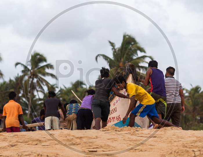 Benaulim,Goa/India- Aug 2 2020: Indian fishermen getting ready for venturing into sea for their daily catch. Indian fishing industry.