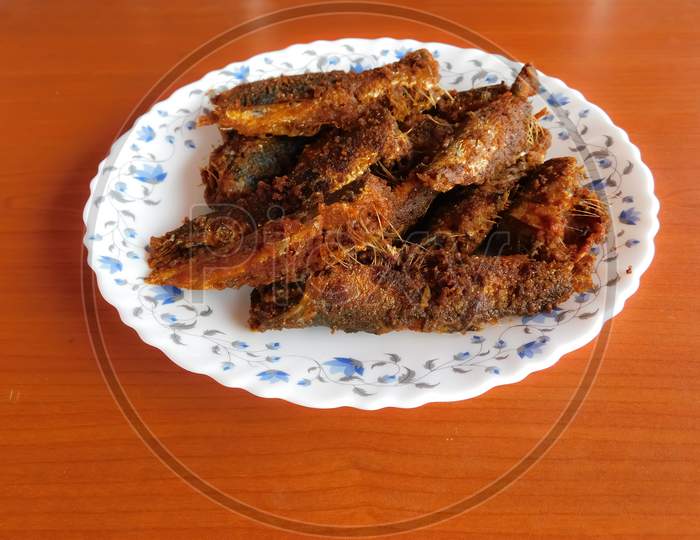 Delicious Fish Fry Dish With A Plate Isolated On A Wooden Surface