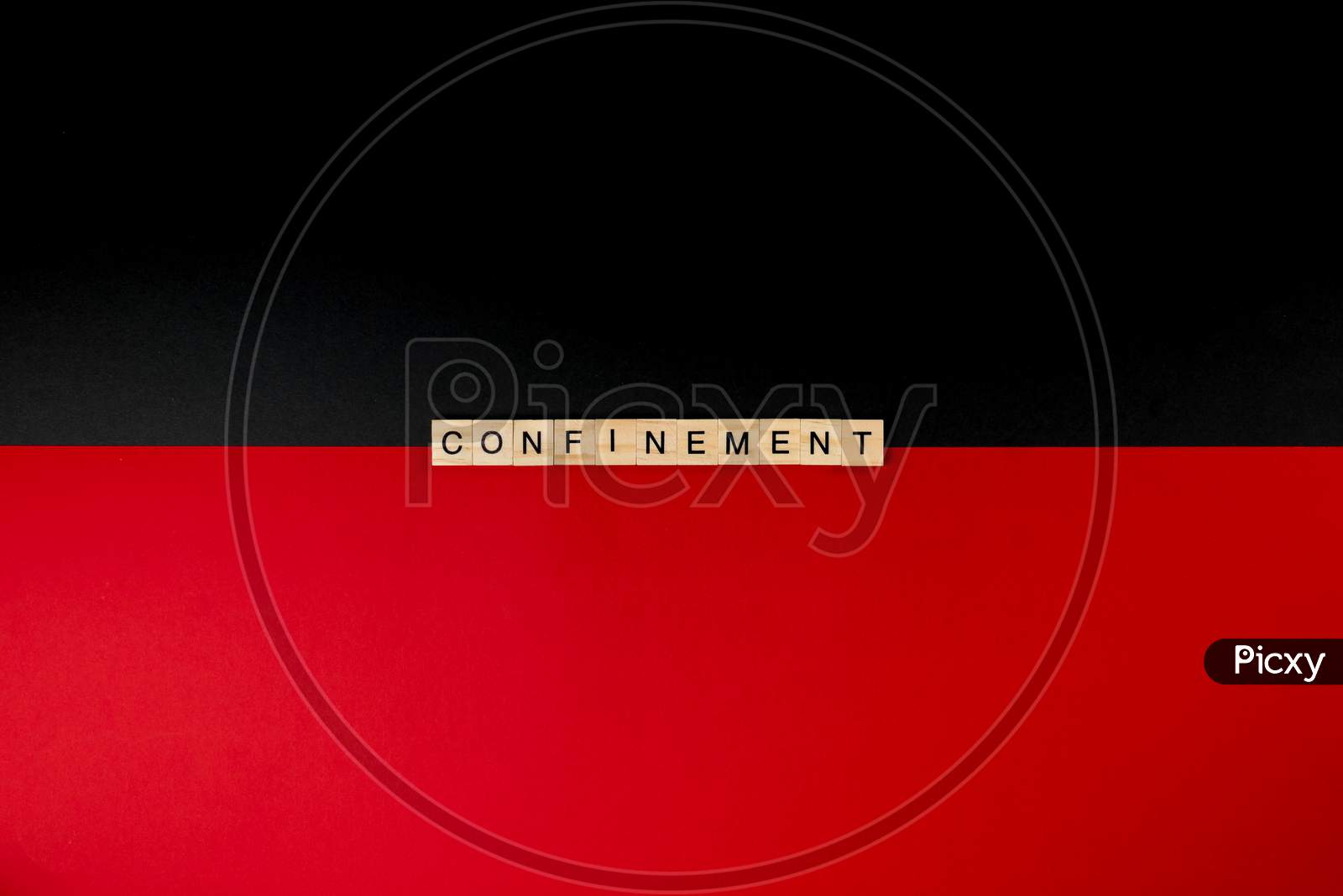 Wooden Letters On A Red And Black Background Forming The Word “Confinement”. Second Wave During Coronavirus Pandemic Concept.