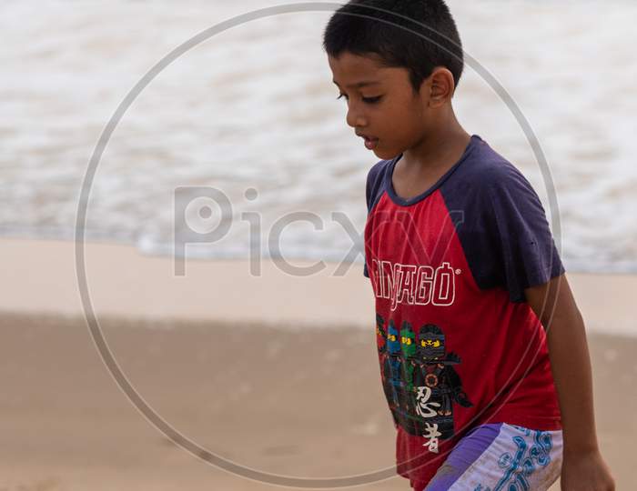 Margao, Goa/India - May 2 2020 : Indian children/kids playing on the beach side at Arossim Beach, Goa in the evening.