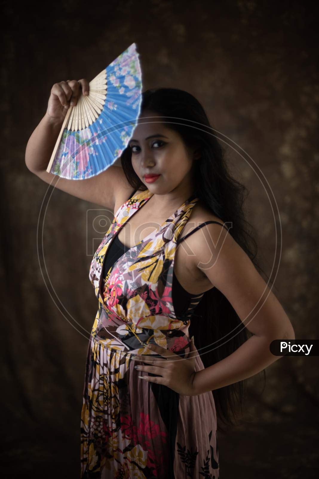 Studio Portrait Of An Young Indian Girl In Western Backless Dress In Front Of Textured Background. Fashion Portrait Photography
