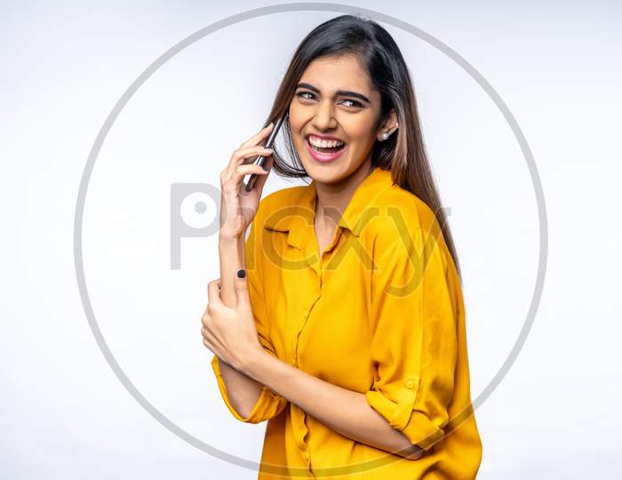 Smiling Young Indian woman speaking on a Phone