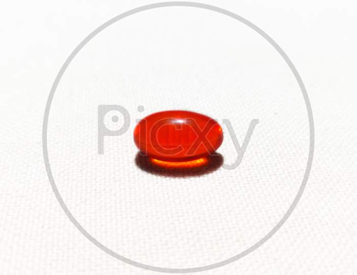 Red capsule isolated in white background