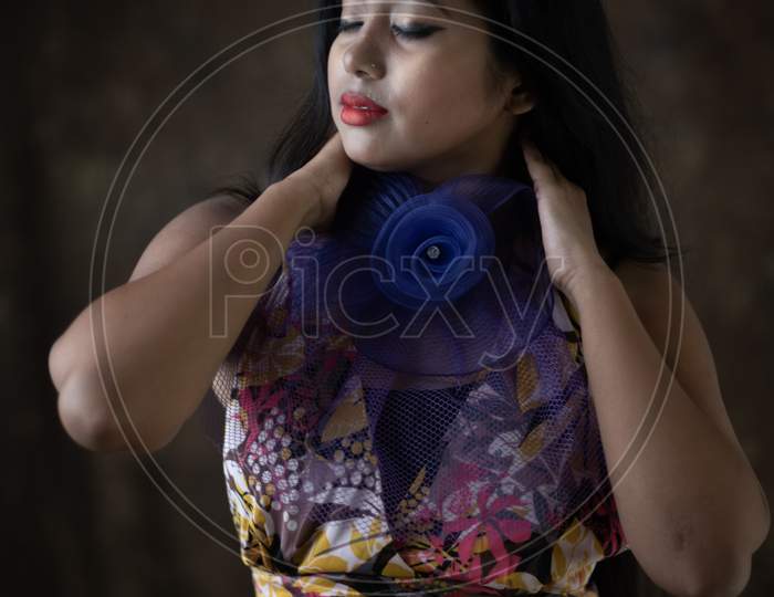 Studio Portrait Of An Young Indian Girl In Western Backless Dress In Front Of Textured Background. Fashion Portrait Photography