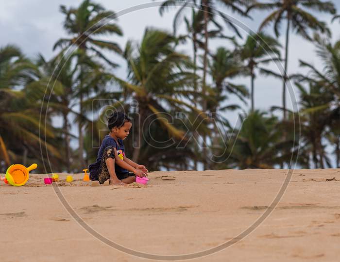 Margao, Goa/India - May 2 2020 : Indian children/kids playing on the beach side at Arossim Beach, Goa in the evening.