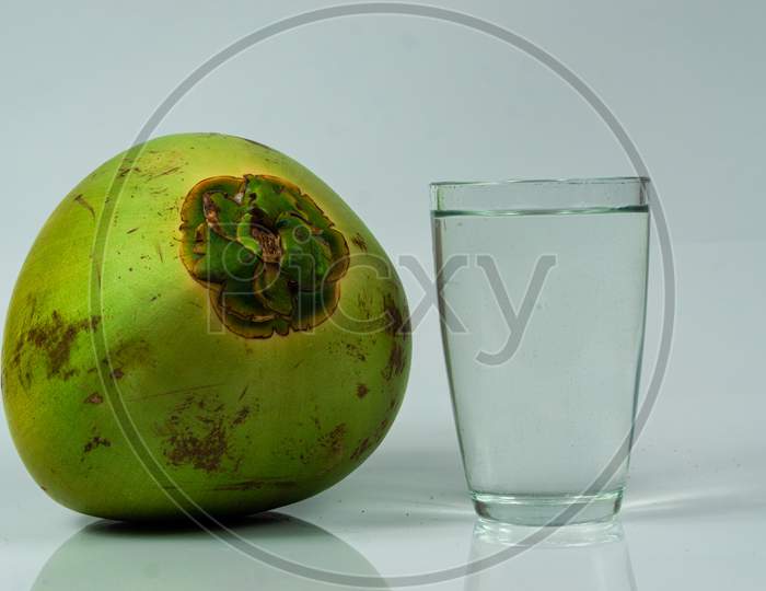 Tender Coconut With A Glass On A White Table