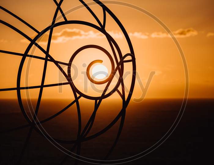 Sun During The Sunset Coinciding With An Sculpture With Copy Space