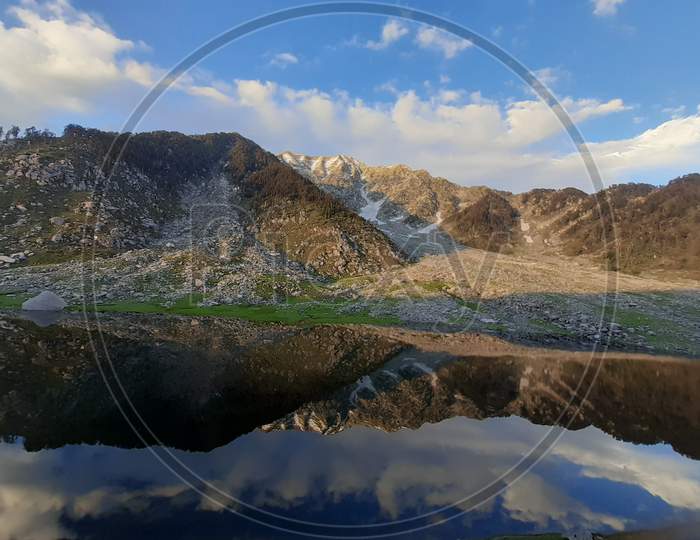 Reflection of Minkiani pass mountain on fresh water Kareri Lake