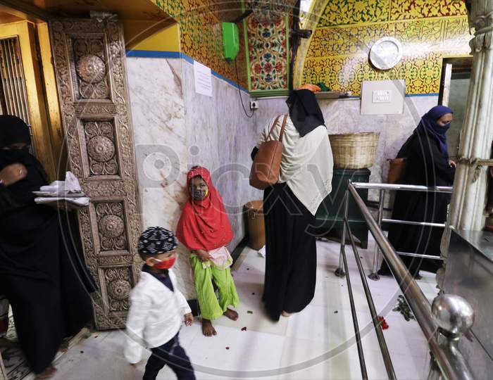 Women and kids wearing protective masks are seen inside a shrine after religious places reopened for the public amid the spread of the coronavirus disease (COVID-19) in Mumbai, India in November, 2020.