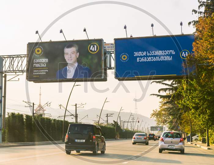 1 November, 2020. Tbilisi.Georgia.Parliament Elections 2020 Agitation.Giant Billboard By The Road  With Passing Cars. Georgian Dreams Party Agitation Poster With Face Of  Giorgi Gakharia.