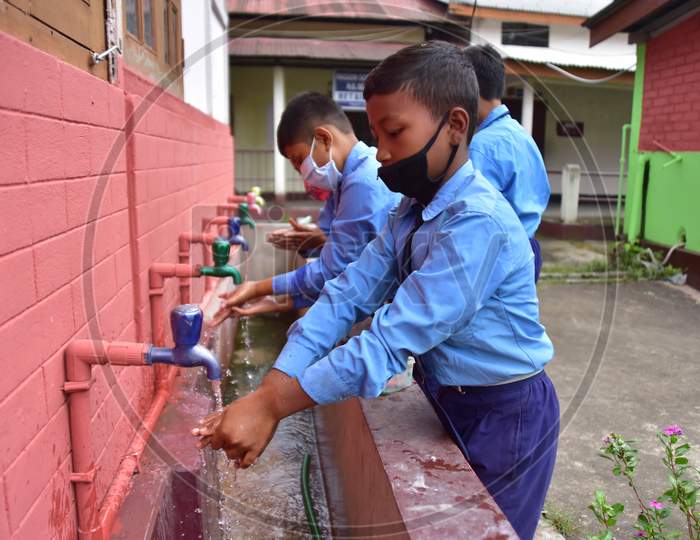 Students wash their hands  at a  School after schools re-opened following a gap of more then seven months due to coronavirus pandemic in Nagaon District of Assam on Nov 2,2020.