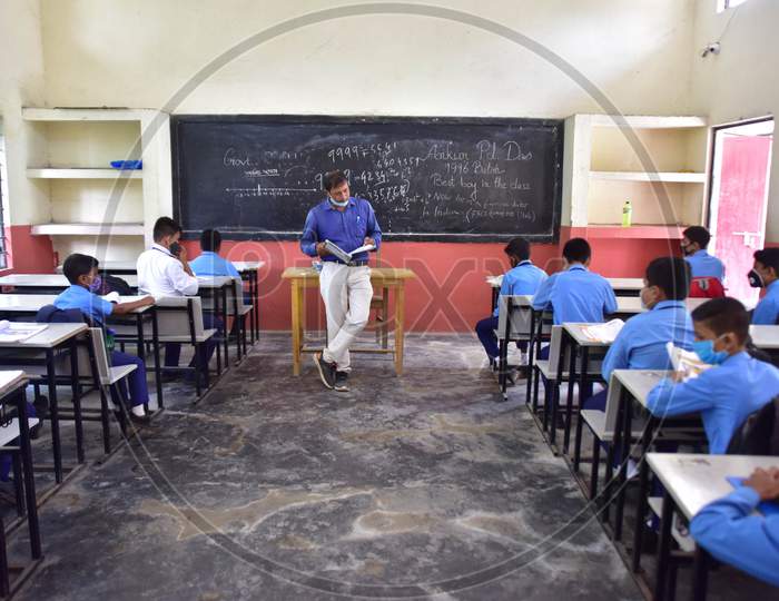 Students attend a class at a  School after schools re-opened following a gap of more then seven months due to coronavirus pandemic in Nagaon District of Assam on Nov 2,2020.