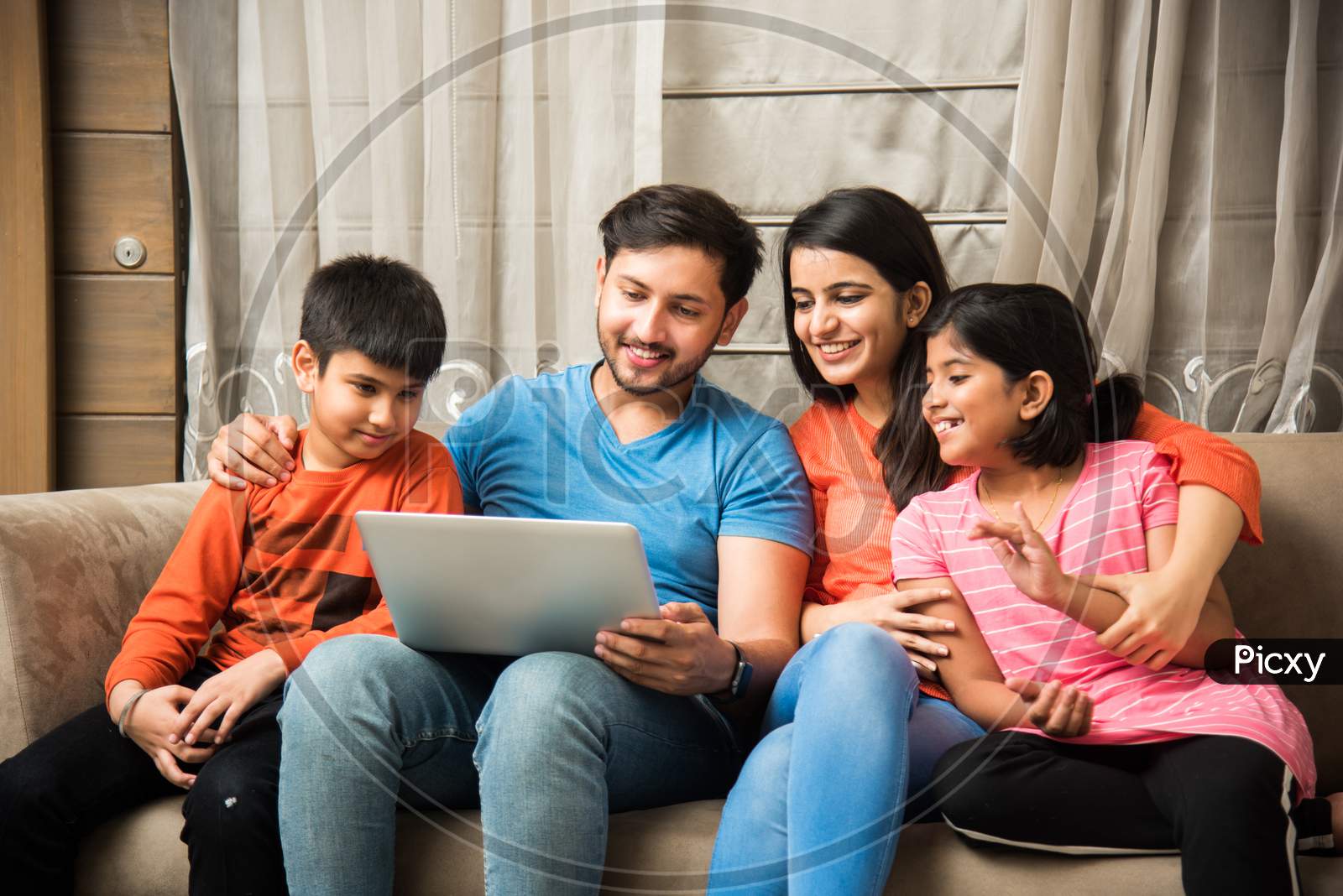 Indian family using laptop or smartphone