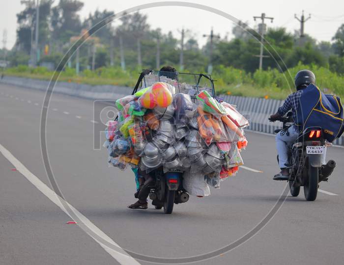 Street Vendors Selling Products Into Motorcycle On Road
