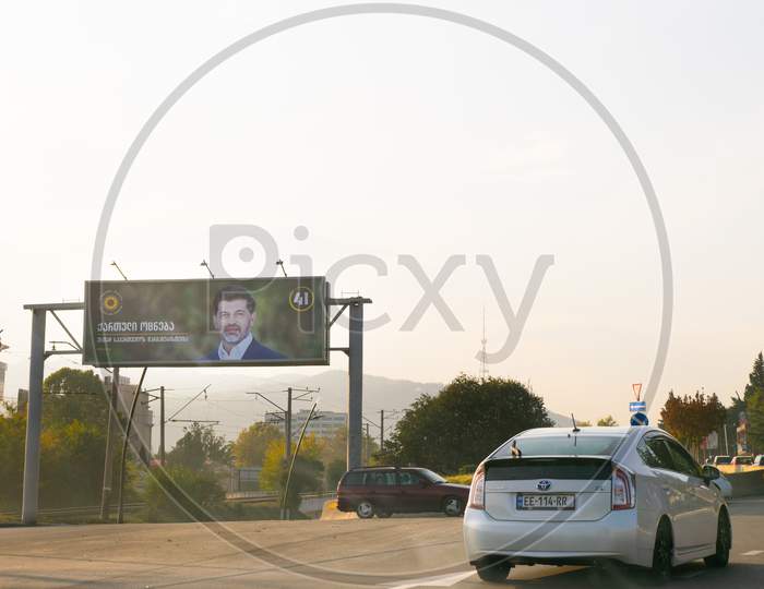 1 November, 2020. Tbilisi.Georgia.Parliament Elections 2020 Agitation.Giant Billboard By The Road  With Passing Cars. Georgian Dreams Party Agitation Poster.