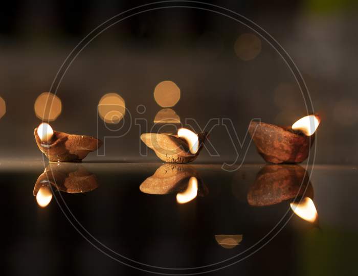 Diwali Diya With golden Bokeh Light Background