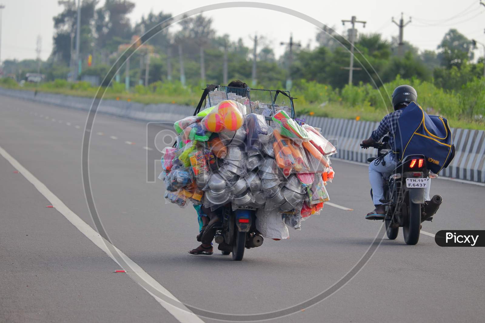 Street Vendors Selling Products Into Motorcycle On Road