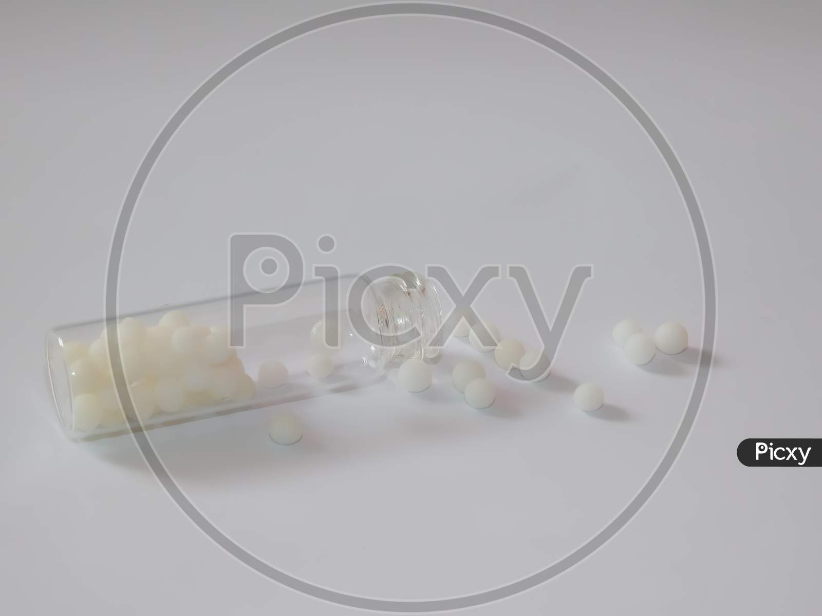 Closeup Of White Capsules With A Bottle Isolated On White Background