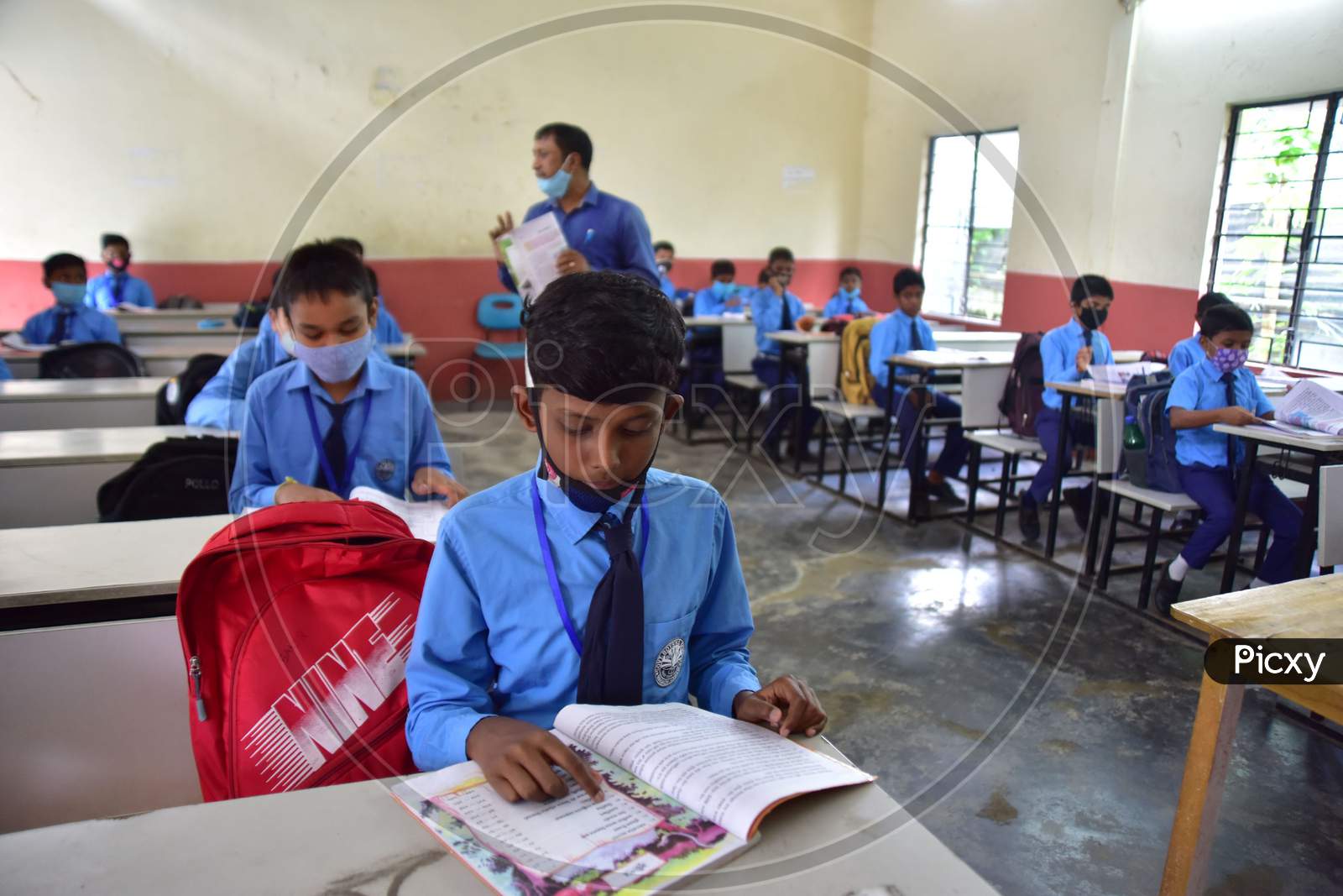 Students attend a class at a  School after schools re-opened following a gap of more then seven months due to coronavirus pandemic in Nagaon District of Assam on Nov 2,2020.