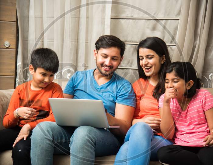 Indian family using laptop or smartphone