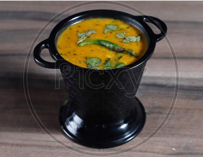 Authentic Indian Popular Food Dal Fry Or Traditional Indian Soup Lentils On Rustic Wooden Background. Selective Focus