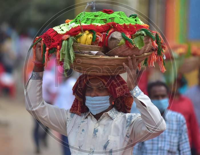 Hindu devotees  wearing mask  as they arrive to pay obeisance to the "Sun God" on the occasion of Chhath Puja  amid corona virus pandemi  in Nagaon district, in the northeastern state of Assam on Nov 20,2020