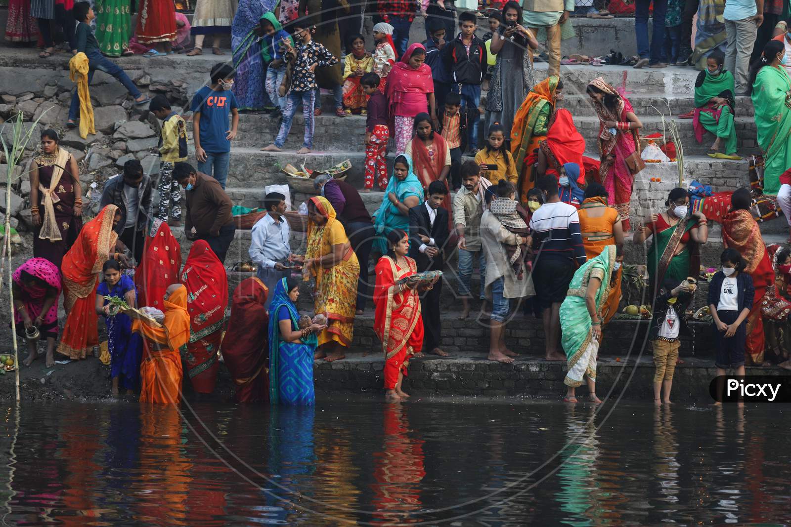 Hindu devotees perform rituals during the Chhath festival in New Delhi- Ghaziabad border on November 20, 2020.