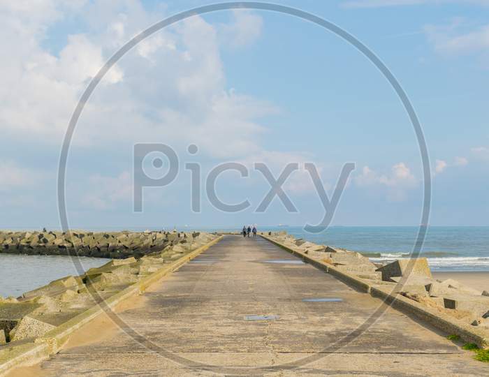 Panoramic View Of A Curvy Footpath Going Towards A Lighthouse At Scheveningen Beach Located In The Hague, Netherlands