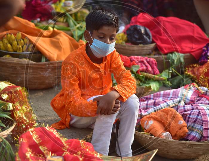 A boy wearing a mask amid corona virus pandemic  on the occasion of Chhath Puja in Nagaon district, in the northeastern state of Assam on Nov 20,2020.