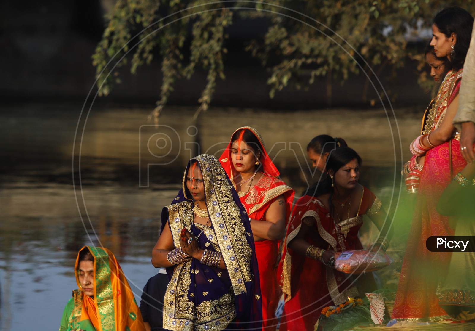 Hindu devotees perform rituals during the Chhath festival in New Delhi- Ghaziabad border on November 20, 2020.