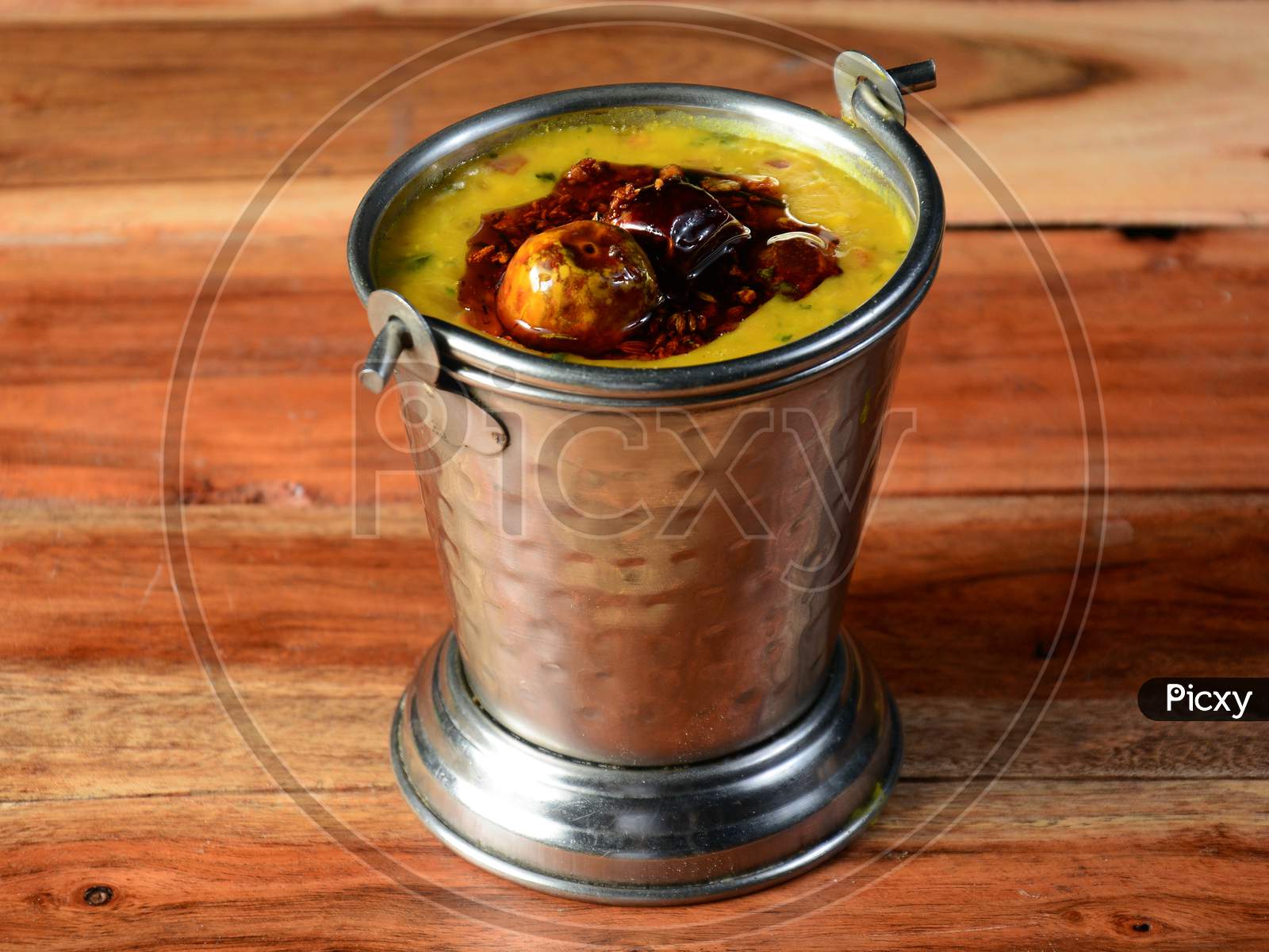 Authentic Indian Popular Food Dal Tadka Curry Or Traditional Indian Soup Lentils On Rustic Wooden Background. Selective Focus