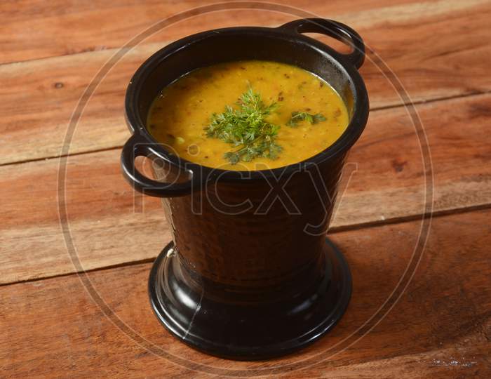 Authentic Indian Popular Food Dal Fry Or Traditional Indian Soup Lentils On Rustic Wooden Background. Selective Focus