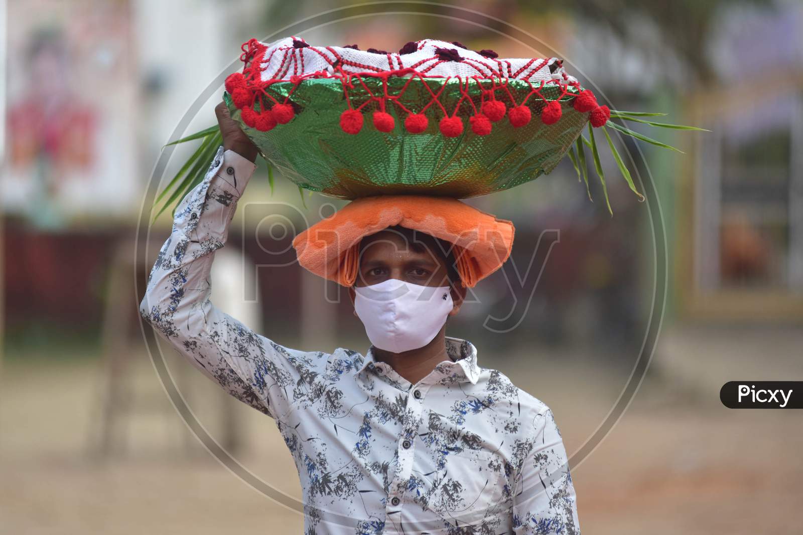 Hindu devotees  wearing mask  as he arrives to pray to the "Sun God" on the occasion of Chhath Puja  amid coronavirus pandemic  in Nagaon district, in the northeastern state of Assam on Nov 20,2020
