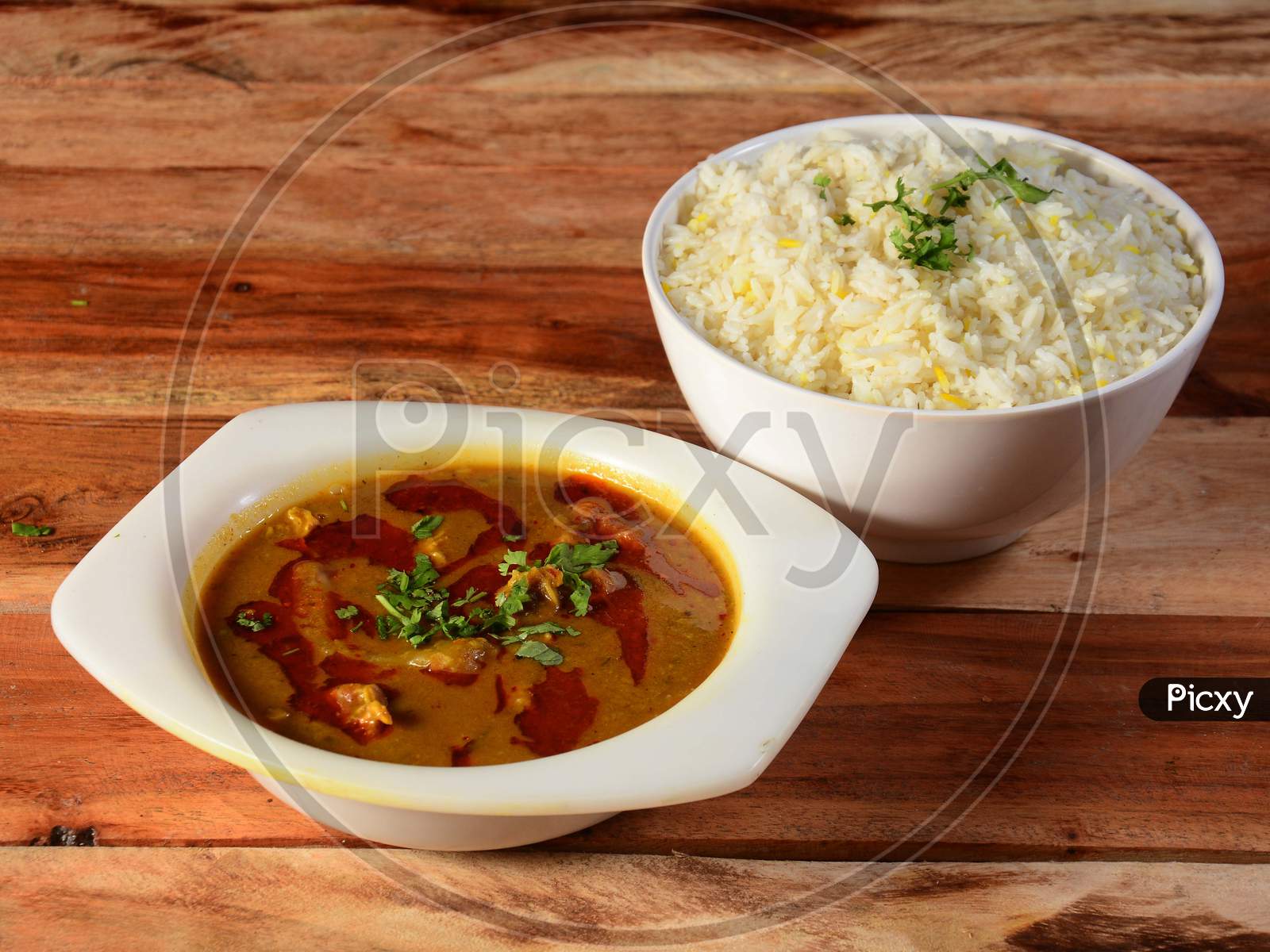 Traditional Indian Cuisine, Beef Curry And Boiled Rice On White Ceramic Bowl On The Rustic Wooden Background