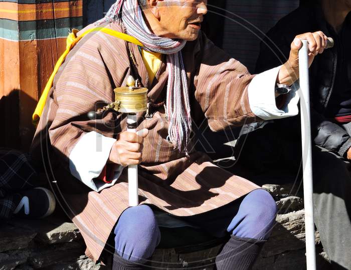 Bhutanese Monk with Prayer wheel