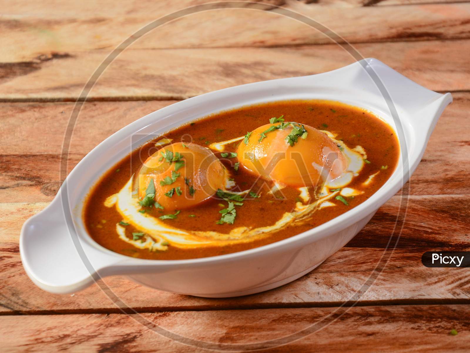 Anda Masala Or Egg Curry Is Popular Indian Spicy Food, Served In A Ceramic Bowl Over Rustic Wooden Background. Selective Focus