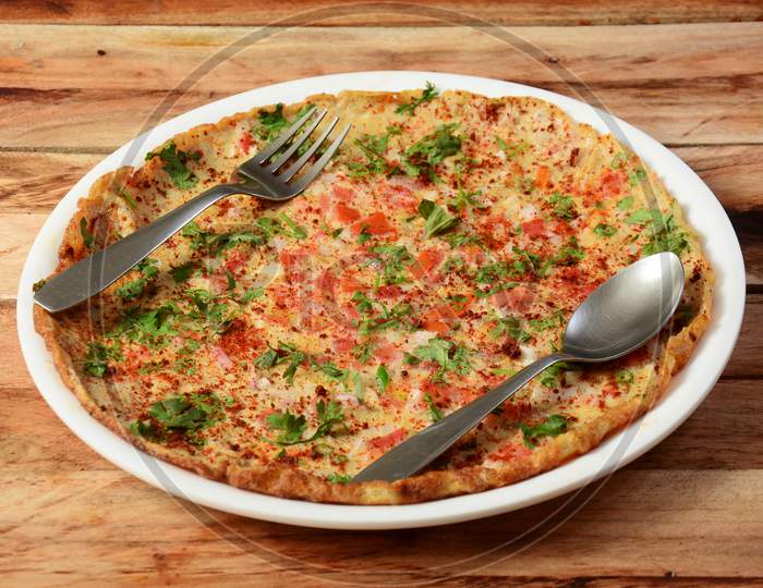 Indian Masala Egg Omelet, Made With Fresh Vegetables Tomato,Onion, Hot Chili Pepper, Parsley.. Served In Rustic Wooden Background, Selective Focus