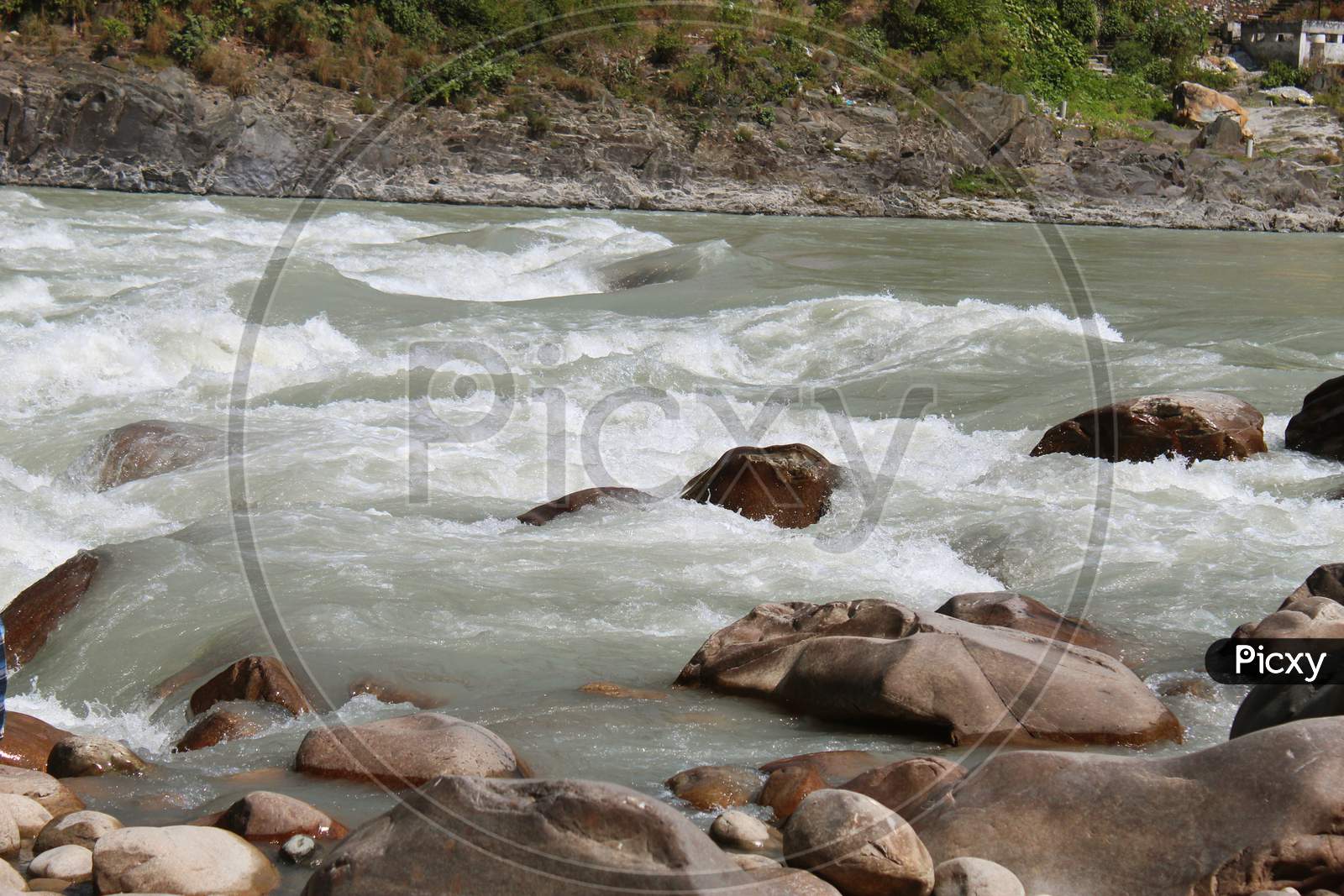 Landscape with mountains, river water, stream water, stream flow. water flowing through stones & rocks.
