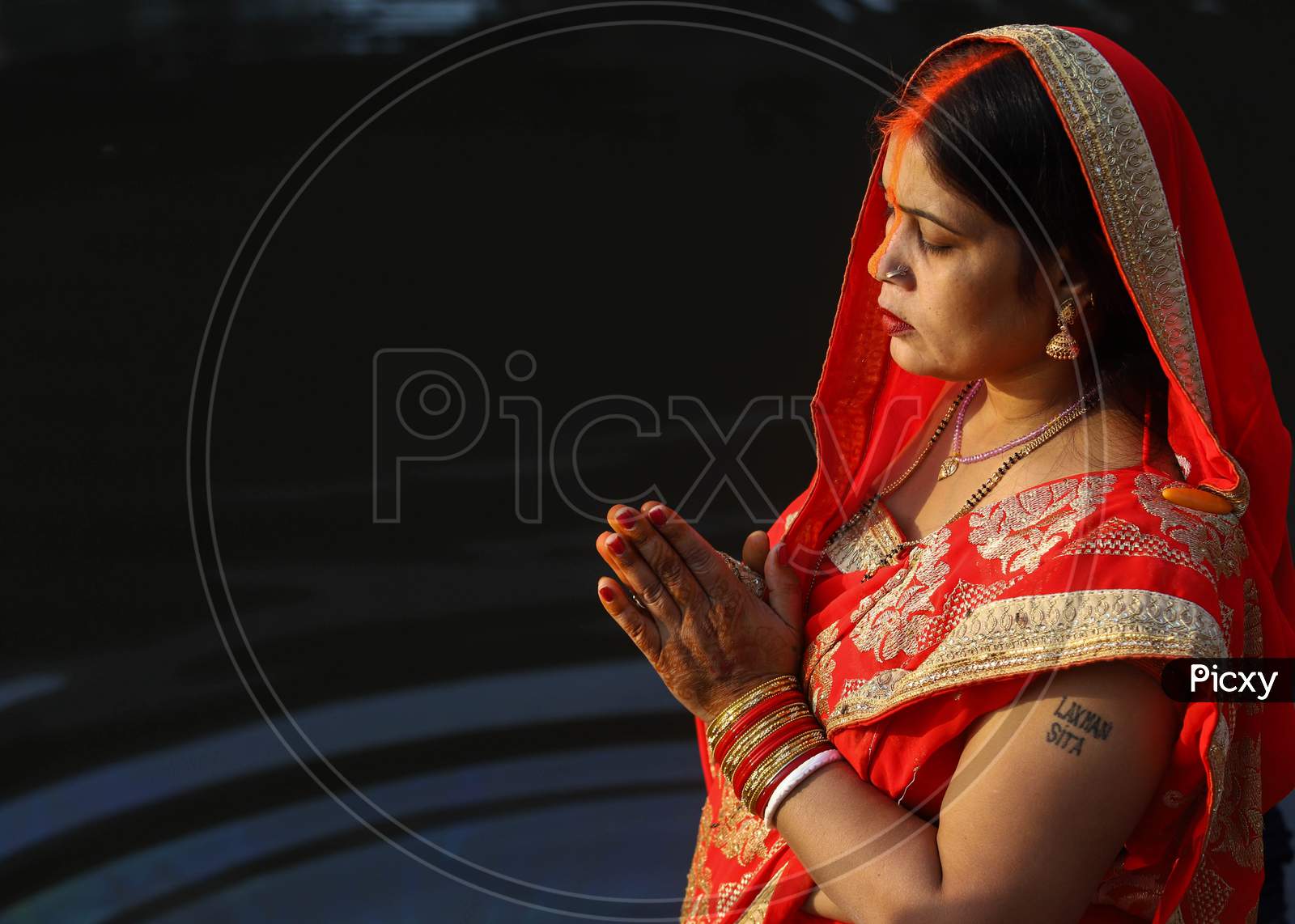 A Hindu devotee performs rituals during the Chhath festival in New Delhi- Ghaziabad border on November 20, 2020.