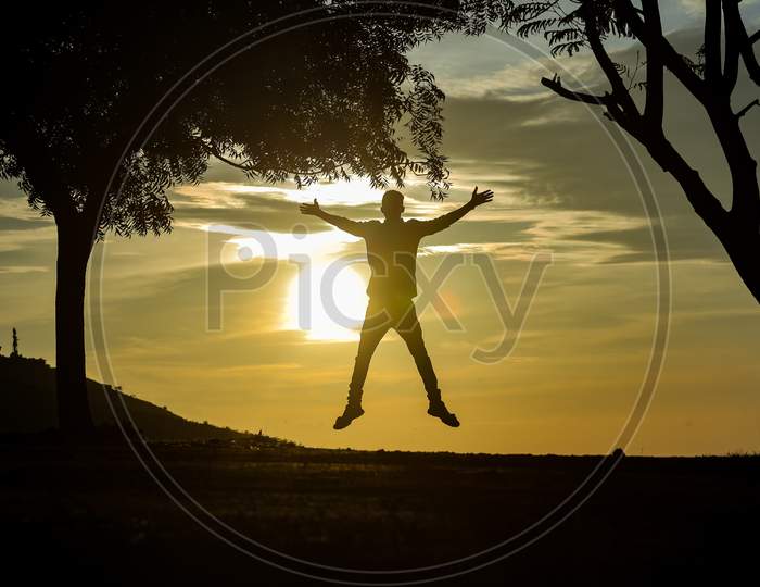 Boy Jumping With Happiness Silhouette