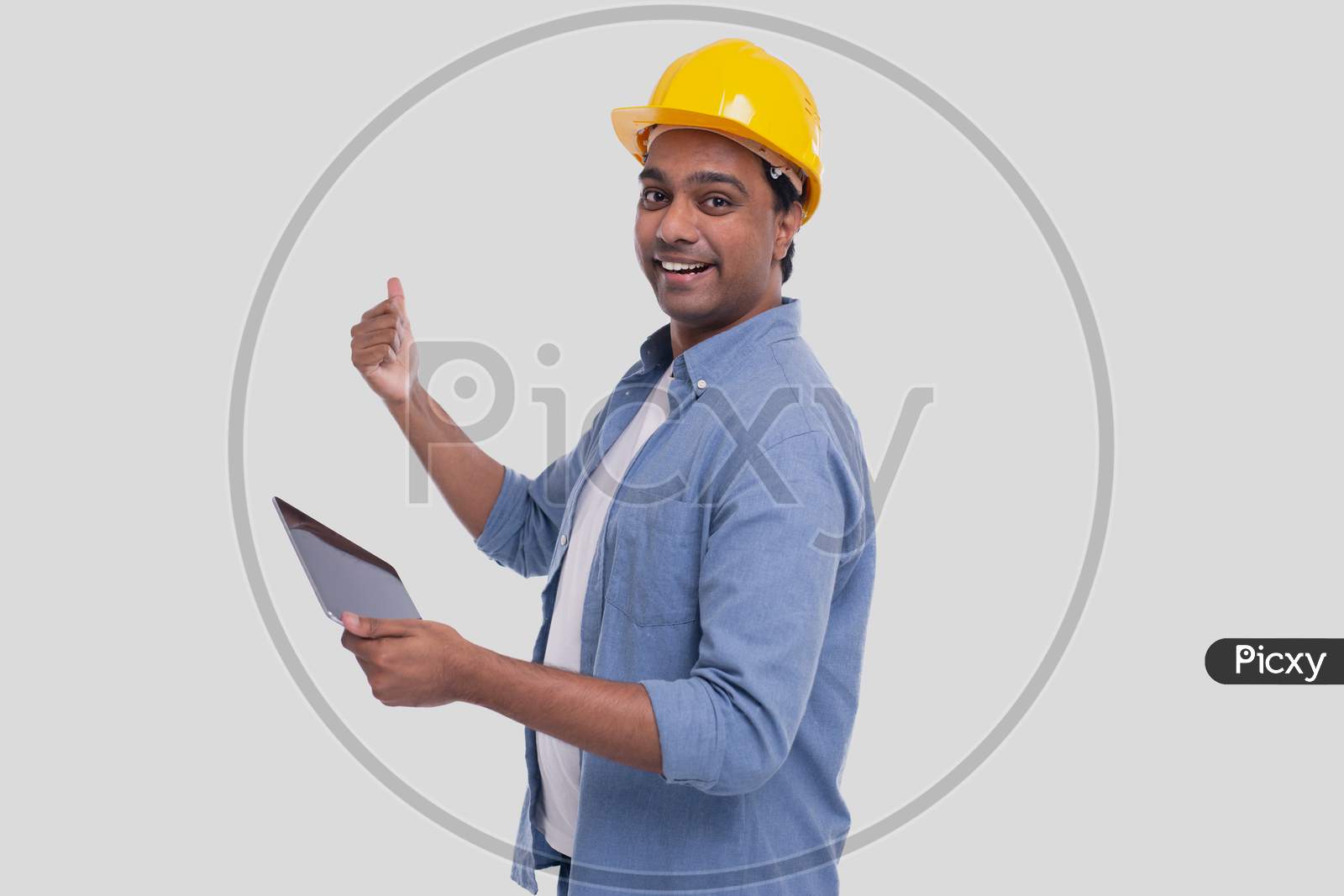 Construction Worker Holding Tablet In Hands Showing Back. Man Using Tablet. Architect Holding Tablet. Yellow Hard Helmet. Worker Isolated